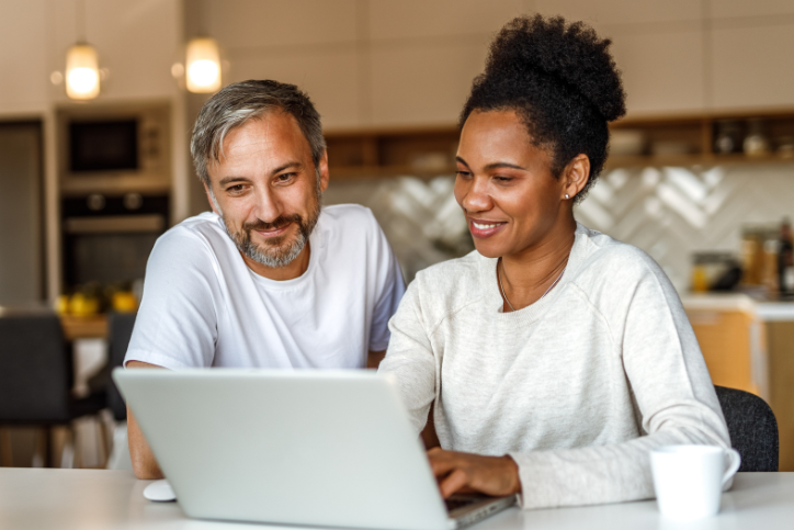 man and woman sat at laptop