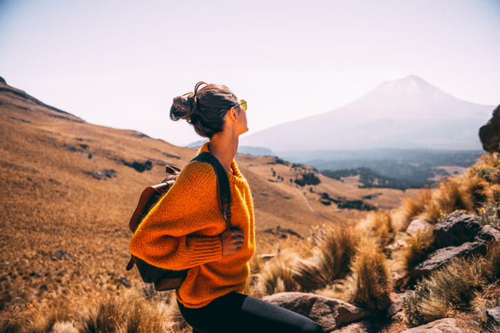 woman in hills looking around at the scenery