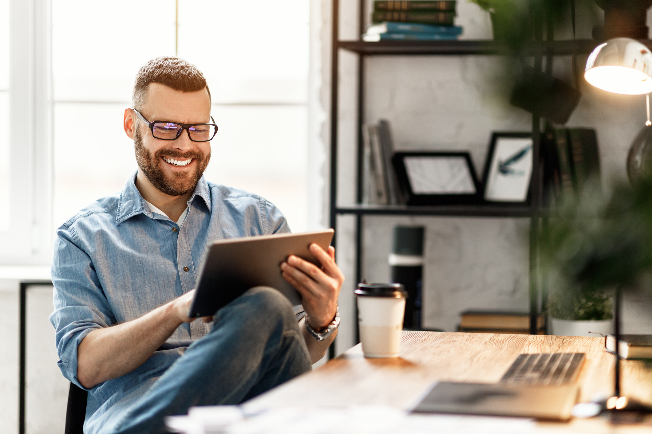 man smiling looking at tablet