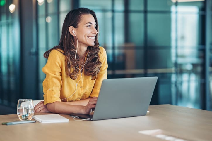 woman smiling working on laptop