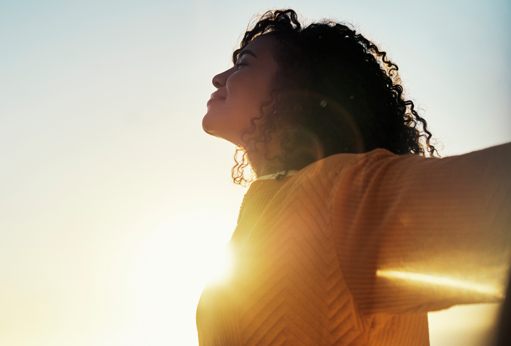 woman smiling looking at the sunset