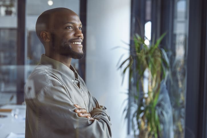 man smiling looking out of the window